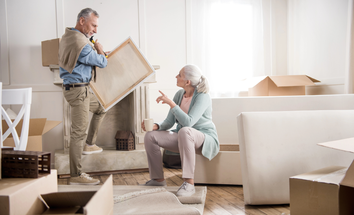 senior couple packing for a move image